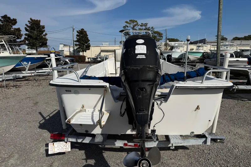 Slide: The Image of 2006 Carolina Skiff 1980 DLX boat on trailer, rear view with outboard motor. - 10