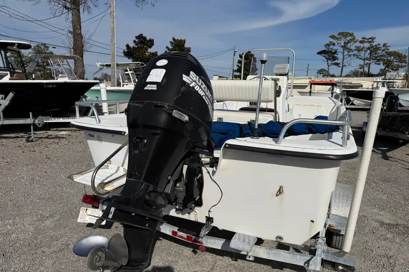 Slide: The Image of 2006 Carolina Skiff 1980 DLX boat with Suzuki outboard motor on trailer. - 11