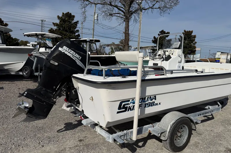 Slide: The Image of 2006 Carolina Skiff 1980 DLX boat with Suzuki outboard motor on trailer. - 13