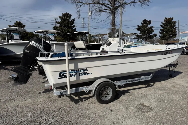 Slide: The Image of 2006 Carolina Skiff 1980 DLX boat on trailer with Suzuki outboard motor. - 14