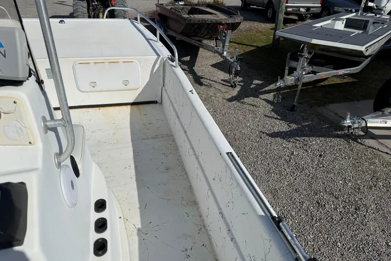 Slide: The Image of 2006 Carolina Skiff 1980 DLX boat interior with trailers in background. - 23
