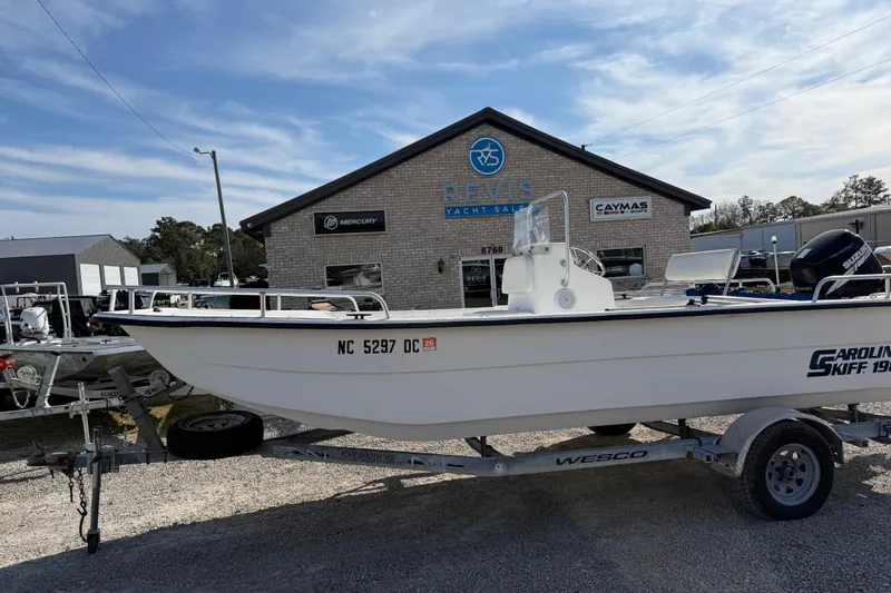 Slide: The Image of 2006 Carolina Skiff 1980 DLX boat on trailer outside yacht sales building. - 6