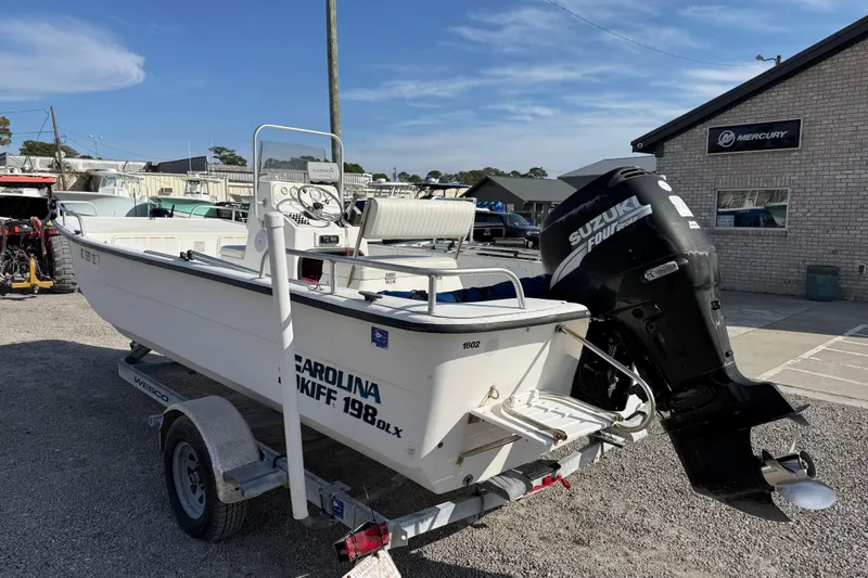 Slide: The Image of 2006 Carolina Skiff 1980 DLX boat with Suzuki outboard motor on trailer. - 8