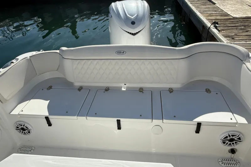 Slide: The Image of 2025 Sea Hunt Ultra 255 SE boat interior with storage compartments and seating. - 11