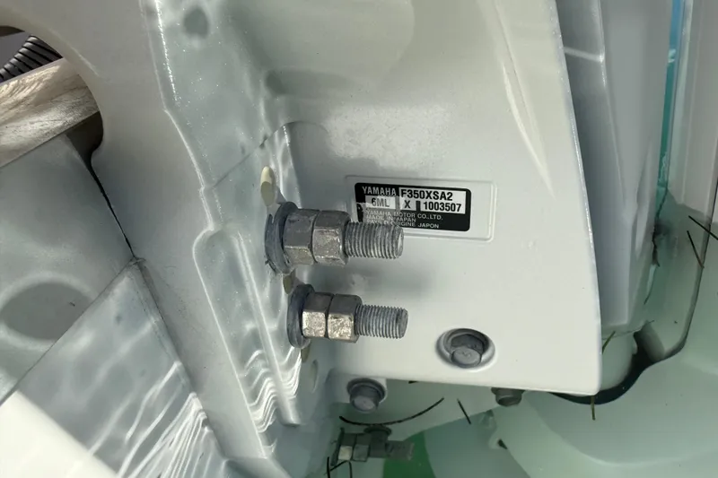 Slide: The Image of Close-up of Yamaha F350XSA2 engine bolts on 2025 Sea Hunt Ultra 255 SE boat. - 12