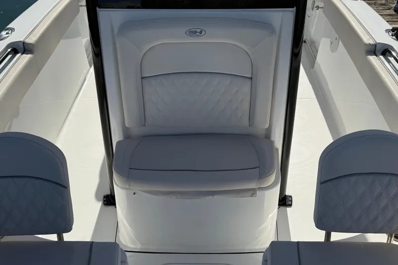 Slide: The Image of 2025 Sea Hunt Ultra 255 SE boat interior with cushioned seating and sleek design. - 23