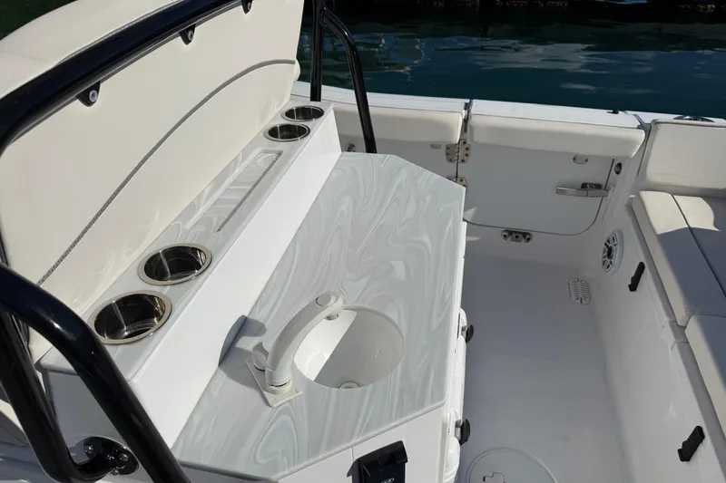 Slide: The Image of 2025 Sea Hunt Ultra 255 SE boat interior with seating and cup holders. - 28