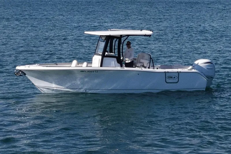 Slide: The Image of 2025 Sea Hunt Ultra 255 SE boat on calm water. - 3