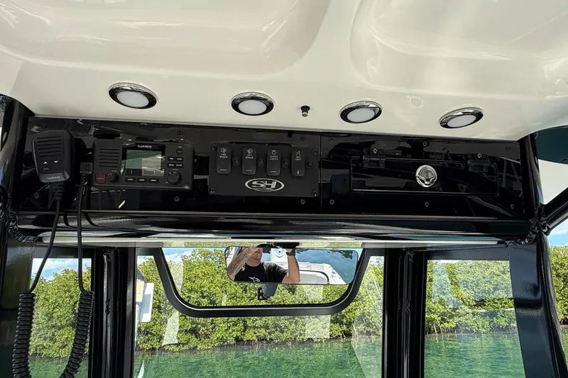 Slide: The Image of 2025 Sea Hunt Ultra 255 SE boat dashboard with Garmin electronics and control panel. - 30