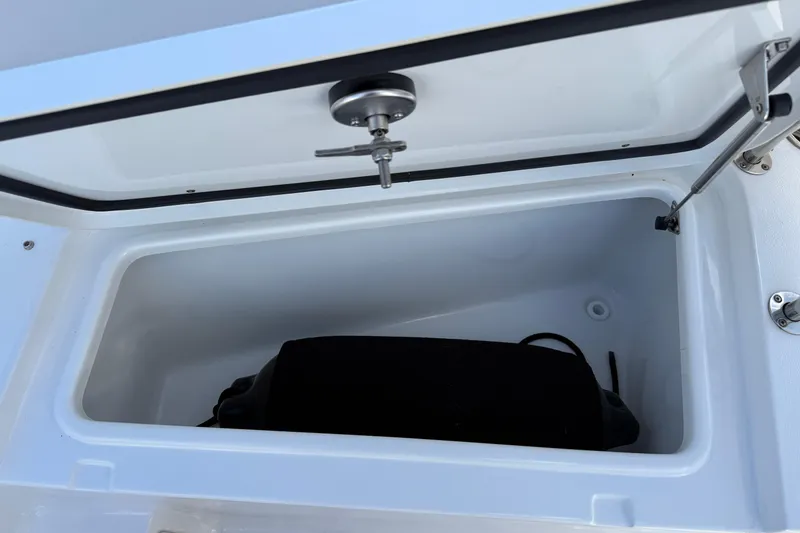 Slide: The Image of Open storage compartment on 2025 Sea Hunt Ultra 255 SE boat. - 34