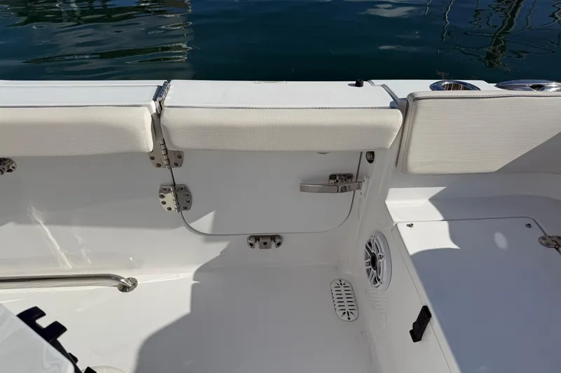 Slide: The Image of 2025 Sea Hunt Ultra 255 SE boat interior with white seating and stainless steel fixtures. - 36