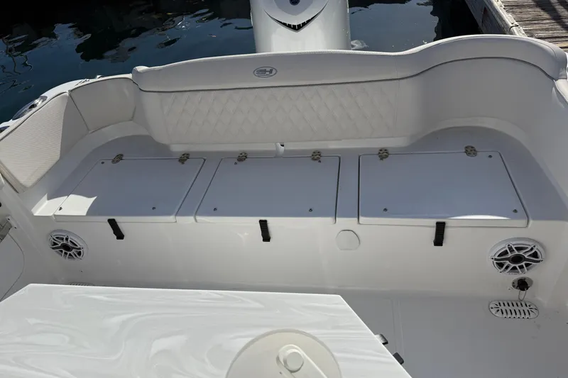 Slide: The Image of 2025 Sea Hunt Ultra 255 SE boat interior with storage compartments and speakers. - 38