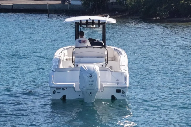 Slide: The Image of Sea Hunt Ultra 255 SE 2025 on calm water. - 4