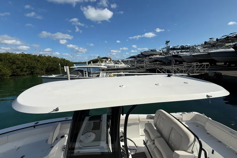 Slide: The Image of 2025 Sea Hunt Ultra 255 SE boat docked under clear blue sky. - 40