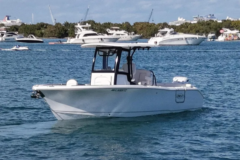 Slide: The Image of Sea Hunt Ultra 255 SE 2025 on water, surrounded by boats. - 6