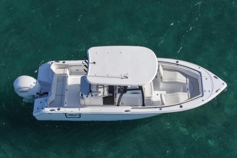 Slide: The Image of 2025 Sea Hunt Ultra 255 SE boat on clear water, aerial view. - 8