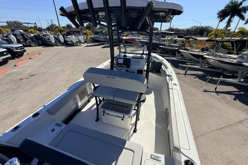 Slide: The Image of 2025 Sea Pro 225FLX Sandbar boat interior, showcasing seating and console features. - 13