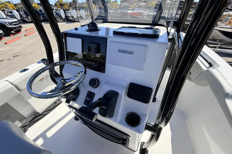 Slide: The Image of 2025 Sea Pro 225FLX Sandbar boat console with steering wheel and Simrad display. - 15