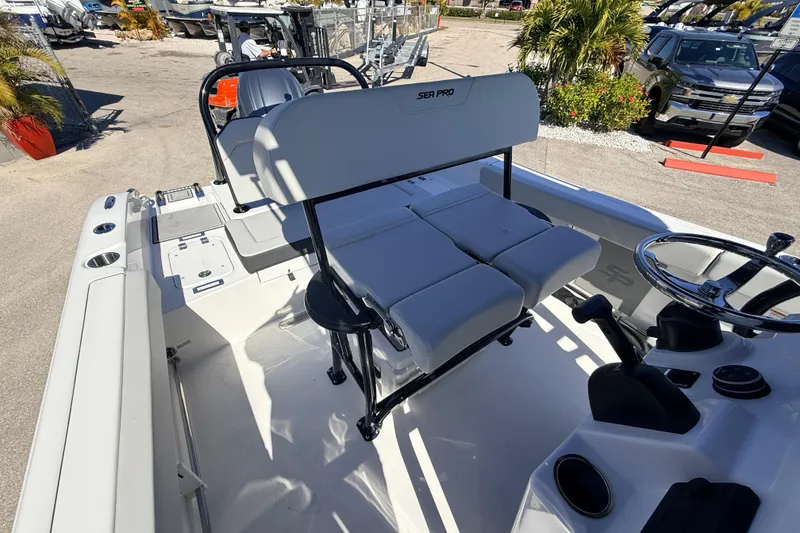 Slide: The Image of 2025 Sea Pro 225FLX Sandbar boat interior with seating and steering wheel. - 17