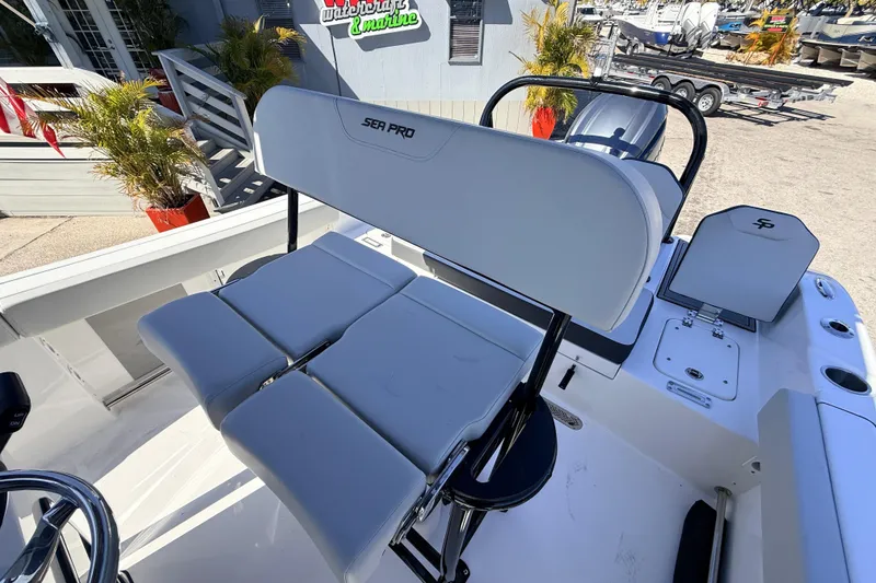 Slide: The Image of 2025 Sea Pro 225FLX Sandbar boat interior with seating and console details. - 19