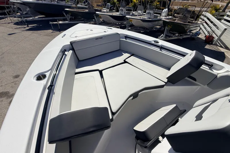 Slide: The Image of 2025 Sea Pro 225FLX Sandbar boat interior with cushioned seating and storage compartments. - 21