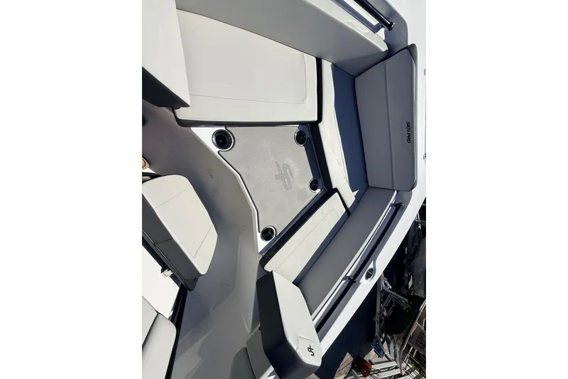 Slide: The Image of 2025 Sea Pro 225FLX Sandbar boat interior with cushioned seating and storage compartments. - 22