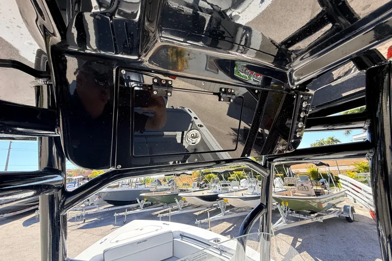 Slide: The Image of 2025 Sea Pro 225FLX Sandbar boat interior with glossy black finish and visible control panel. - 25