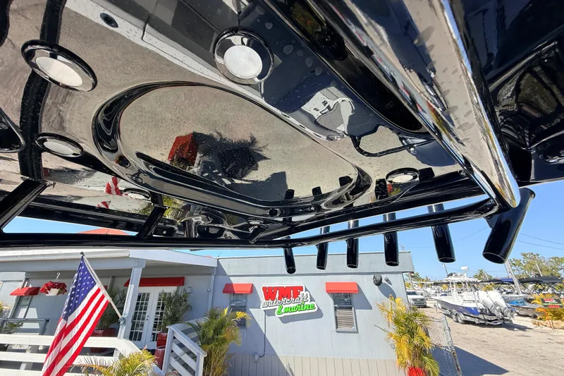 Slide: The Image of 2025 Sea Pro 225FLX Sandbar boat detail with American flag and dealership background. - 26