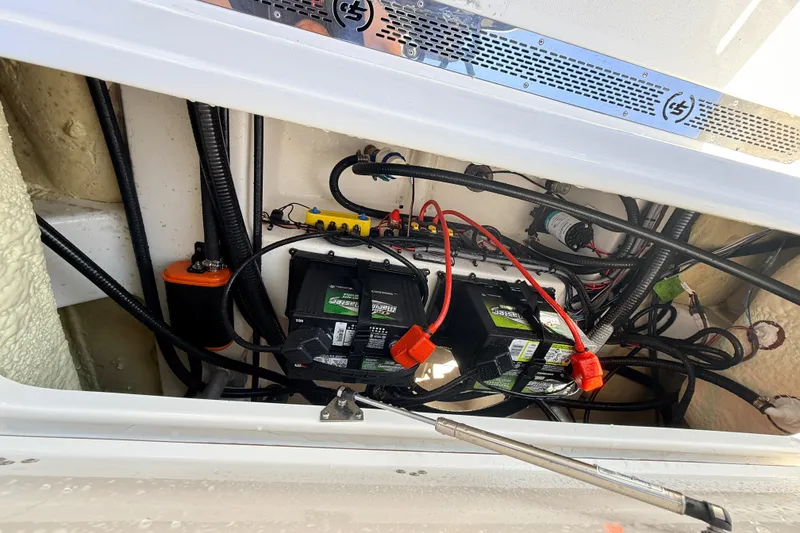Slide: The Image of 2025 Sea Pro 225FLX Sandbar boat battery compartment with wiring and components. - 27