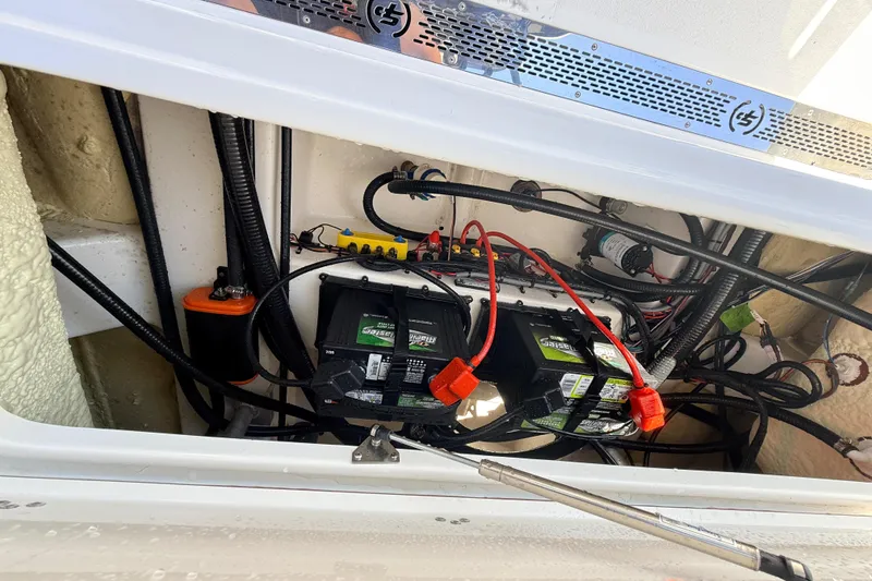 Slide: The Image of 2025 Sea Pro 225FLX Sandbar boat battery compartment with wiring and components. - 28