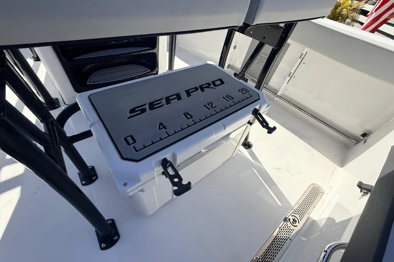Slide: The Image of 2025 Sea Pro 225FLX Sandbar boat deck with branded cooler and measuring scale. - 29