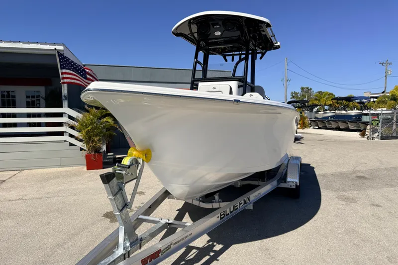 Slide: The Image of 2025 Sea Pro 225FLX Sandbar boat on trailer, parked outdoors under clear blue sky. - 3