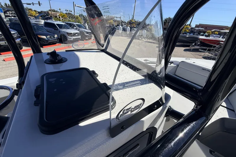 Slide: The Image of 2025 Sea Pro 225FLX Sandbar boat console with windshield, parked outdoors. - 37