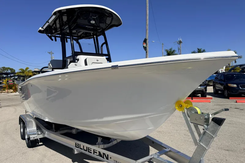 Slide: The Image of 2025 Sea Pro 225FLX Sandbar boat on trailer, parked outdoors under clear blue sky. - 4