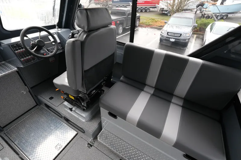 Slide: The Image of Interior of 2026 Hewescraft 270 Alaskan ET Hardtop, featuring steering wheel and seating. - 10