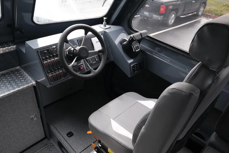 Slide: The Image of Interior of 2026 Hewescraft 270 Alaskan ET Hardtop, featuring steering wheel and control panel. - 11