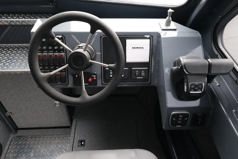 Slide: The Image of Steering console of 2026 Hewescraft 270 Alaskan ET Hardtop with Honda controls. - 12