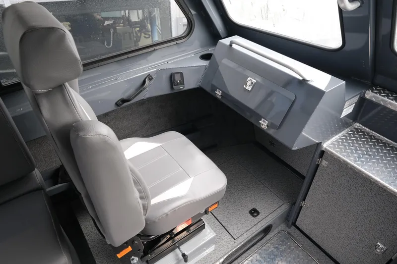 Slide: The Image of 2026 Hewescraft 270 Alaskan ET Hardtop interior with seating and storage compartments. - 13