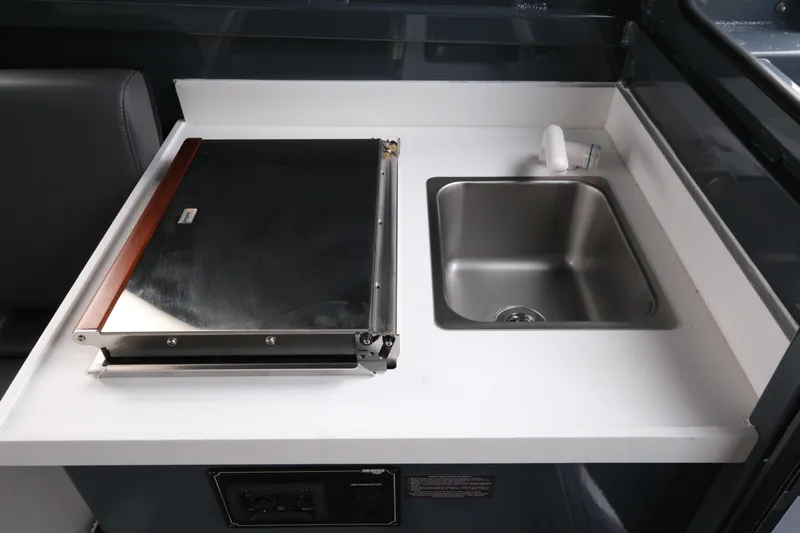 Slide: The Image of Compact kitchen area in 2026 Hewescraft 270 Alaskan ET Hardtop boat. - 17