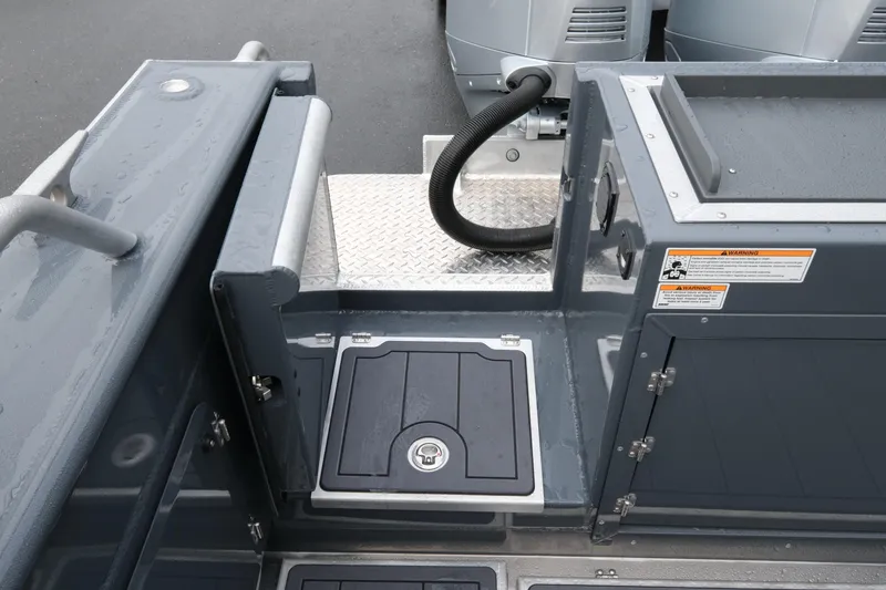 Slide: The Image of 2026 Hewescraft 270 Alaskan ET Hardtop boat deck with storage compartment and safety warnings. - 20