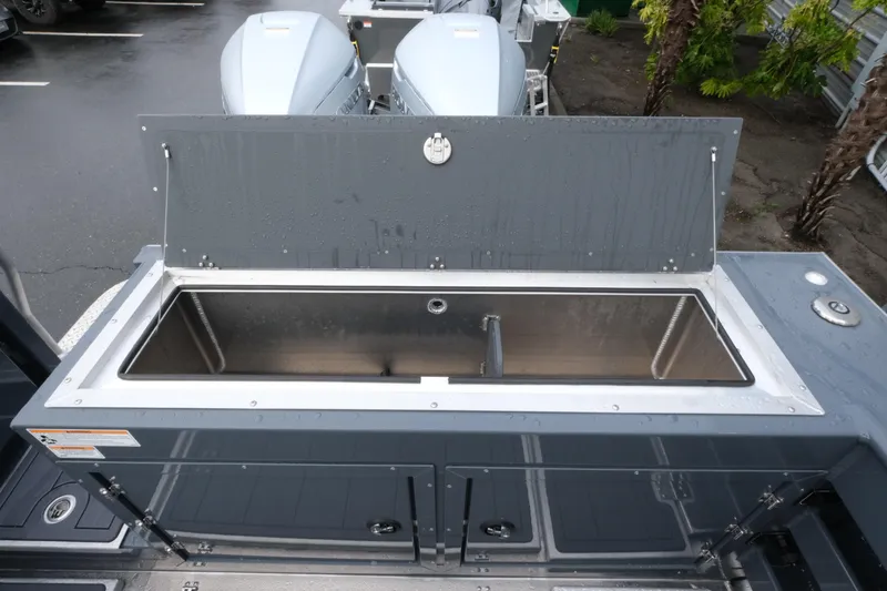 Slide: The Image of 2026 Hewescraft 270 Alaskan ET Hardtop boat with open storage compartment. - 22