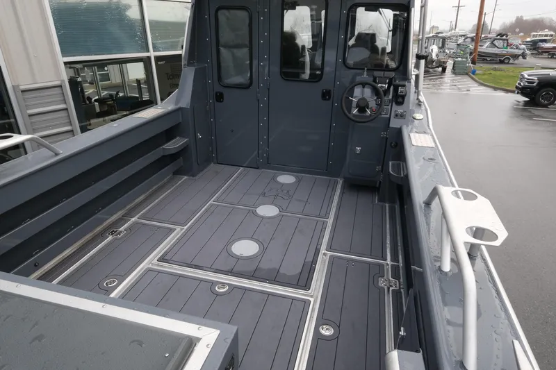 Slide: The Image of 2026 Hewescraft 270 Alaskan ET Hardtop boat interior with spacious deck and steering wheel. - 5