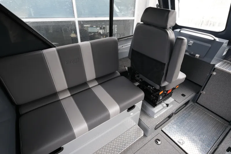 Slide: The Image of Interior of 2026 Hewescraft 270 Alaskan ET Hardtop, featuring modern seating and design. - 9