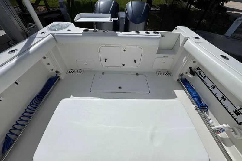 Slide: The Image of 2016 Sailfish 320 CC boat deck with storage compartments and coiled hoses. - 4
