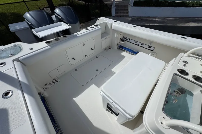 Slide: The Image of 2016 Sailfish 320 CC boat interior with dual engines and fishing amenities. - 5