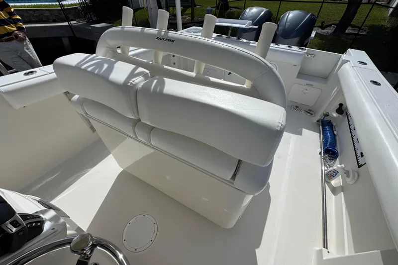 Slide: The Image of 2016 Sailfish 320 CC boat interior with white seating and fishing equipment. - 9