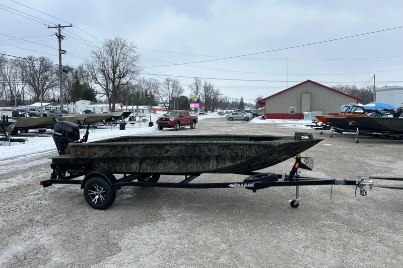 Slide: The Image of 2026 SeaArk 1752 Slayer X Pro boat on trailer in snowy outdoor setting. - 10