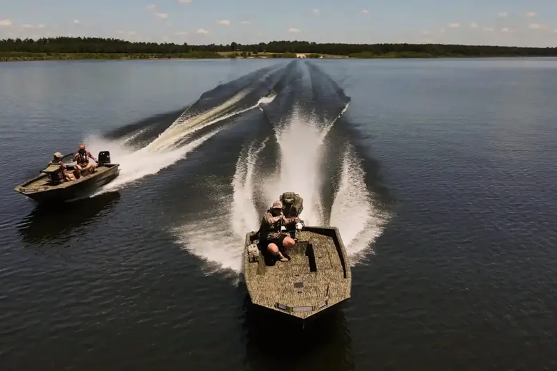 Slide: The Image of Manufacturer Provided Image: 2026 SeaArk 1752 Slayer Pro boats speeding on a calm lake. - 4