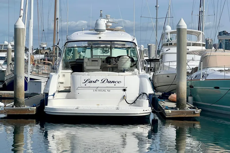 Slide: The Image of 2005 Sea Ray 500 Sundancer yacht docked at marina, named "Last Dance." - 1