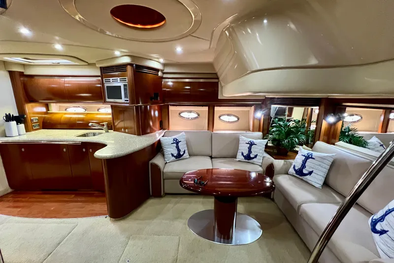 Slide: The Image of Luxurious interior of 2005 Sea Ray 500 Sundancer yacht with elegant seating and modern kitchen. - 14